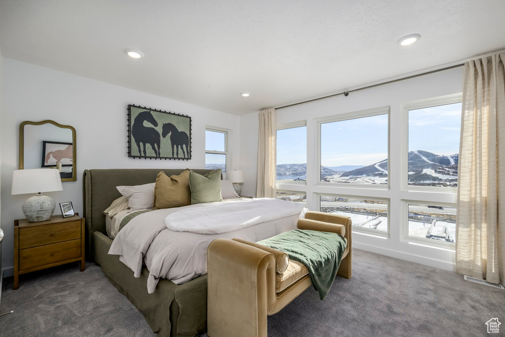 Carpeted bedroom with recessed lighting, a mountain view, and visible vents
