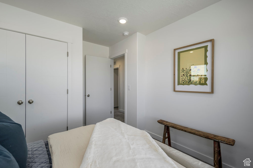Bedroom featuring a closet and baseboards