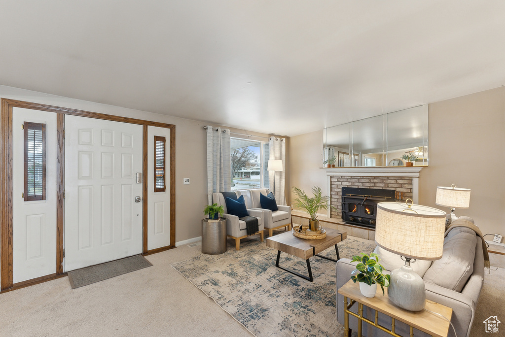 Carpeted living room featuring a brick fireplace