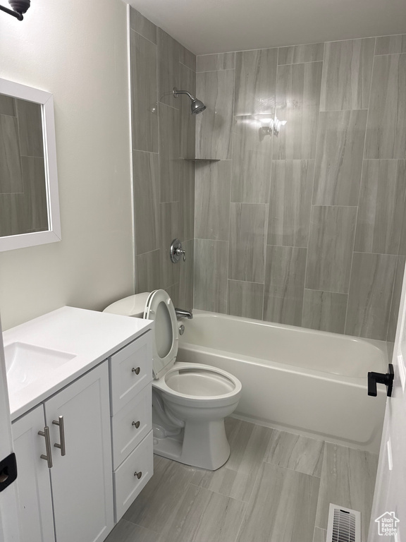 Full bathroom with vanity, shower / bath combination, and toilet