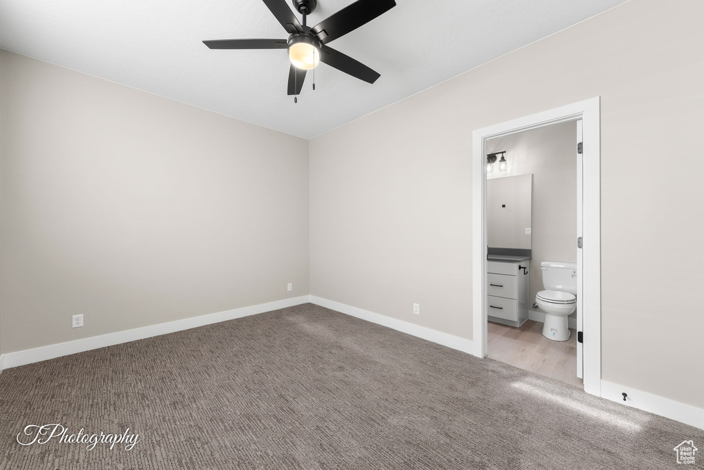 Unfurnished bedroom featuring ensuite bathroom, ceiling fan, and light colored carpet