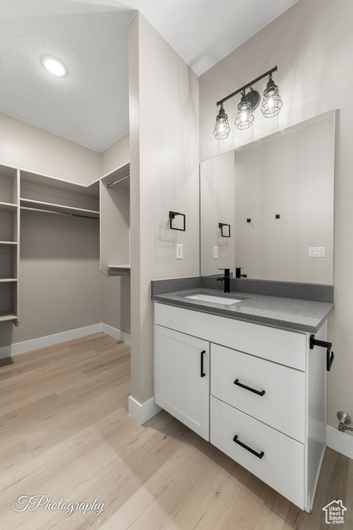 Bathroom with vanity and wood-type flooring