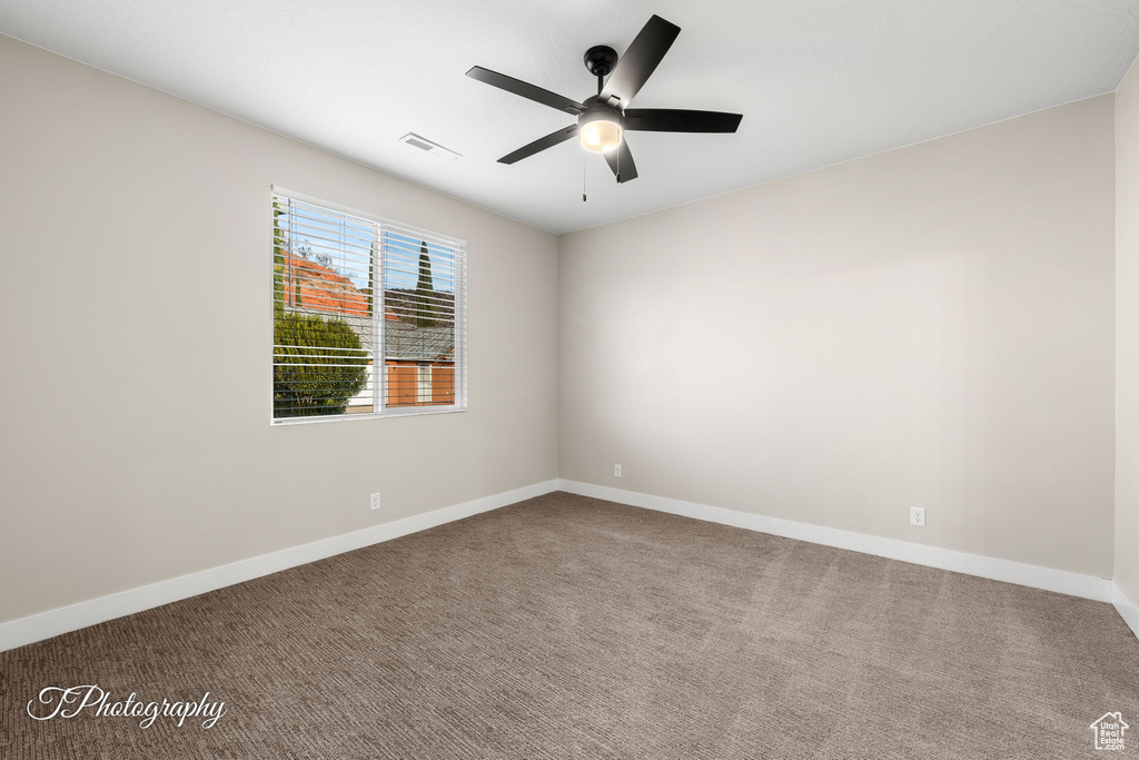 Unfurnished room featuring ceiling fan and carpet floors