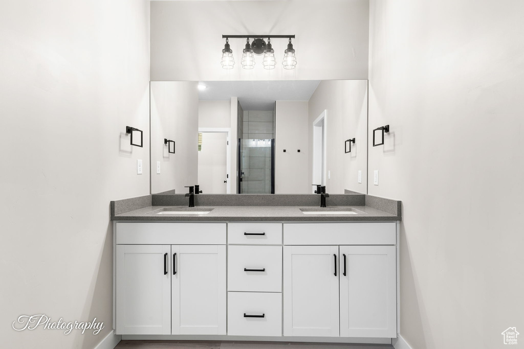 Bathroom featuring vanity and a shower with shower door