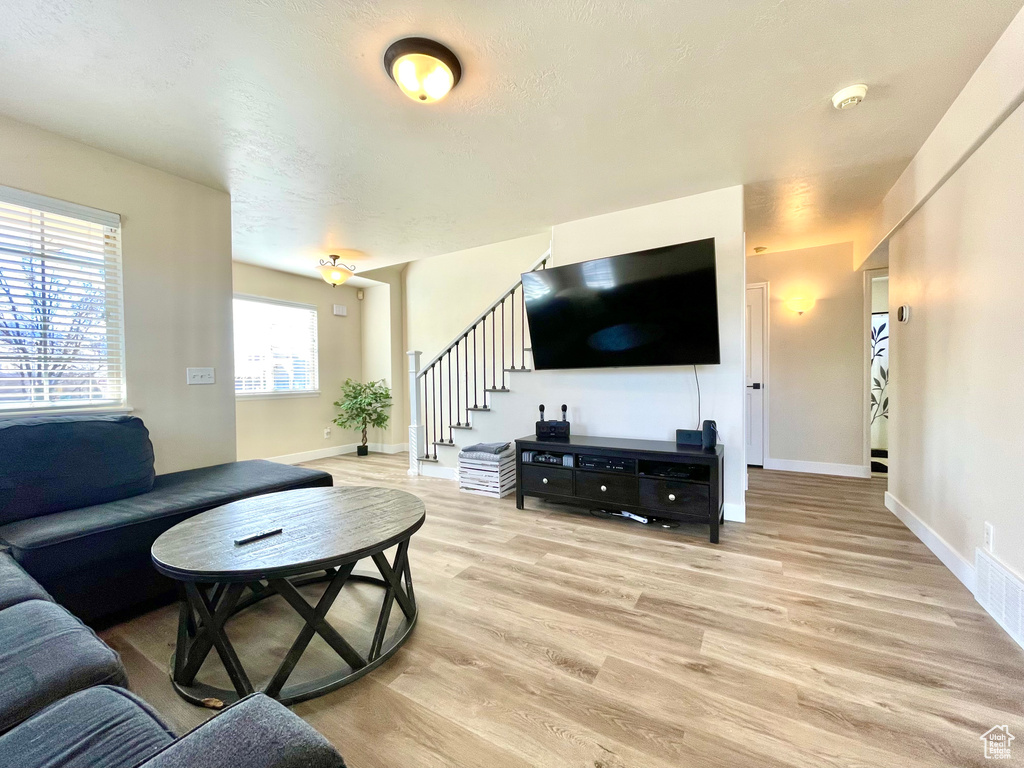 Living room with light hardwood / wood-style flooring