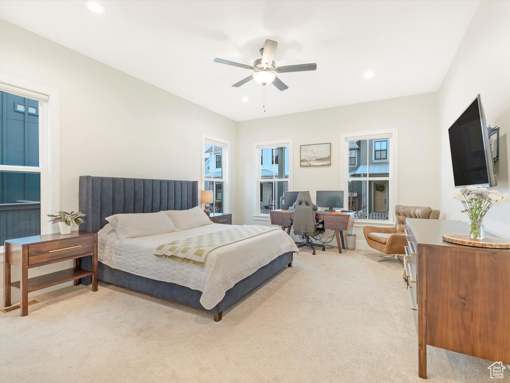 Bedroom featuring light carpet and ceiling fan