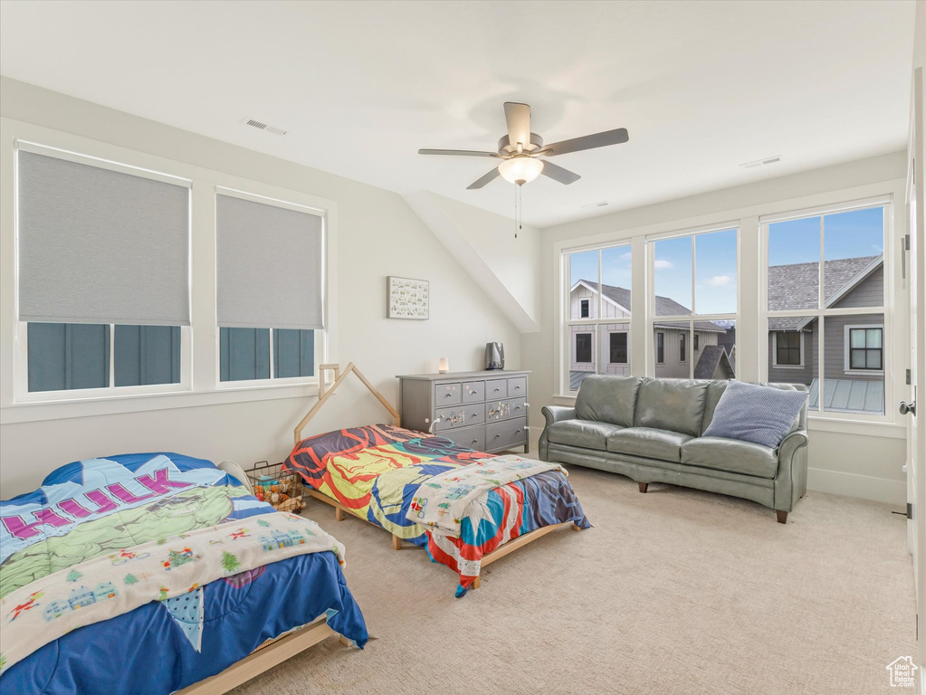 Carpeted bedroom featuring ceiling fan