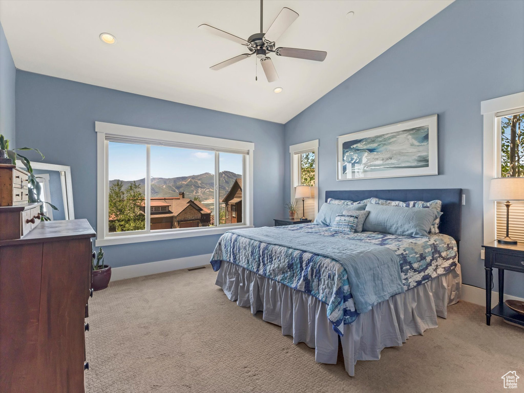 Bedroom featuring light colored carpet, multiple windows, a mountain view, lofted ceiling, and recessed lighting