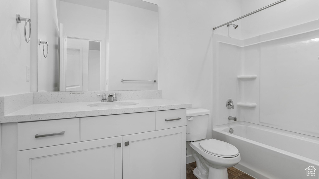 Full bath with toilet, vanity, and shower / washtub combination