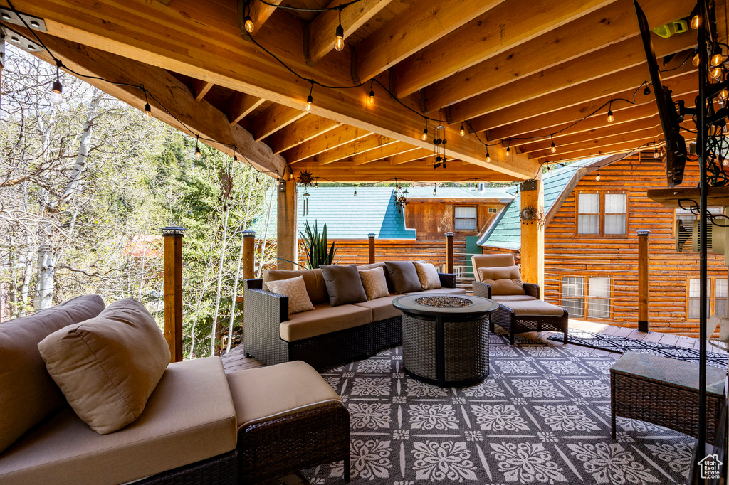 View of patio / terrace featuring an outdoor living space with a fire pit and fence