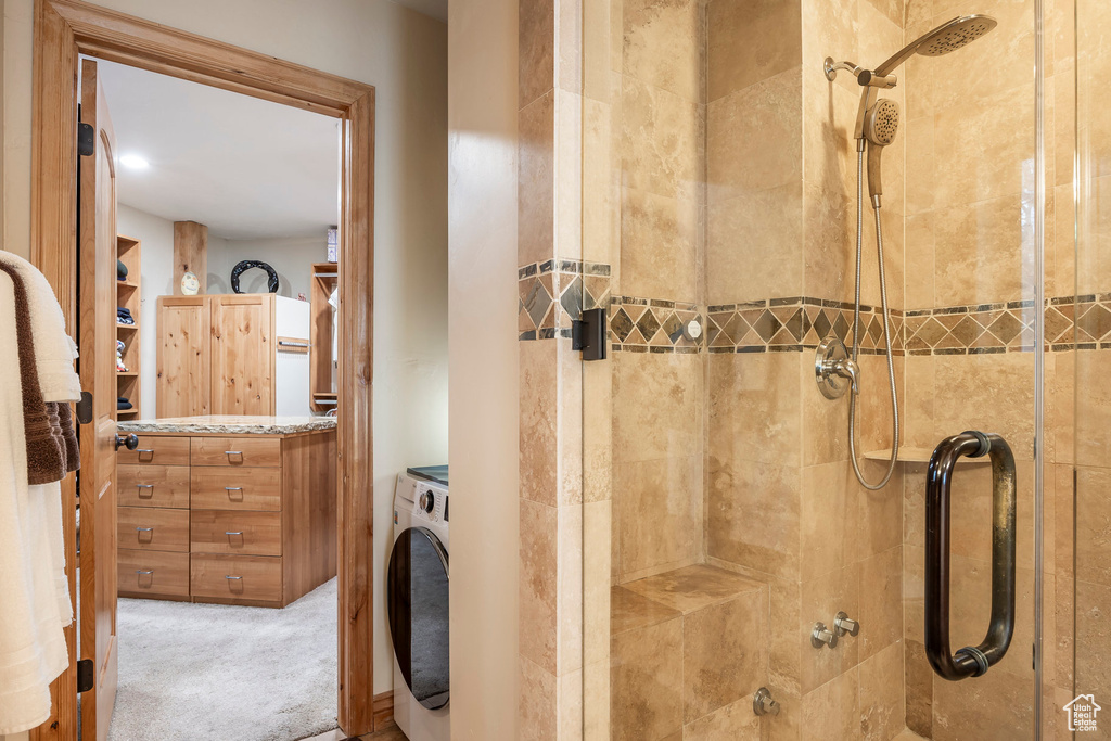 Bathroom featuring washer / dryer and tiled shower