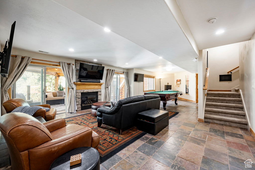 Living room featuring baseboards, healthy amount of natural light, pool table, stairway, and recessed lighting