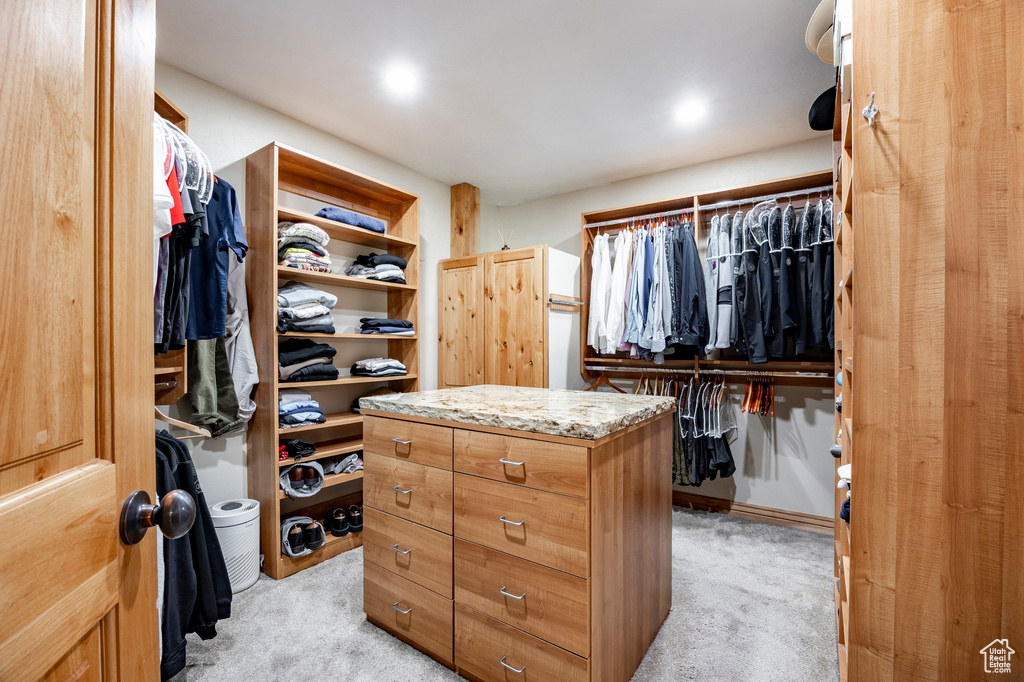 Walk in closet with light carpet