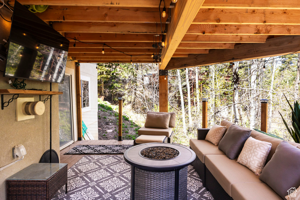 View of patio featuring an outdoor living space with a fire pit
