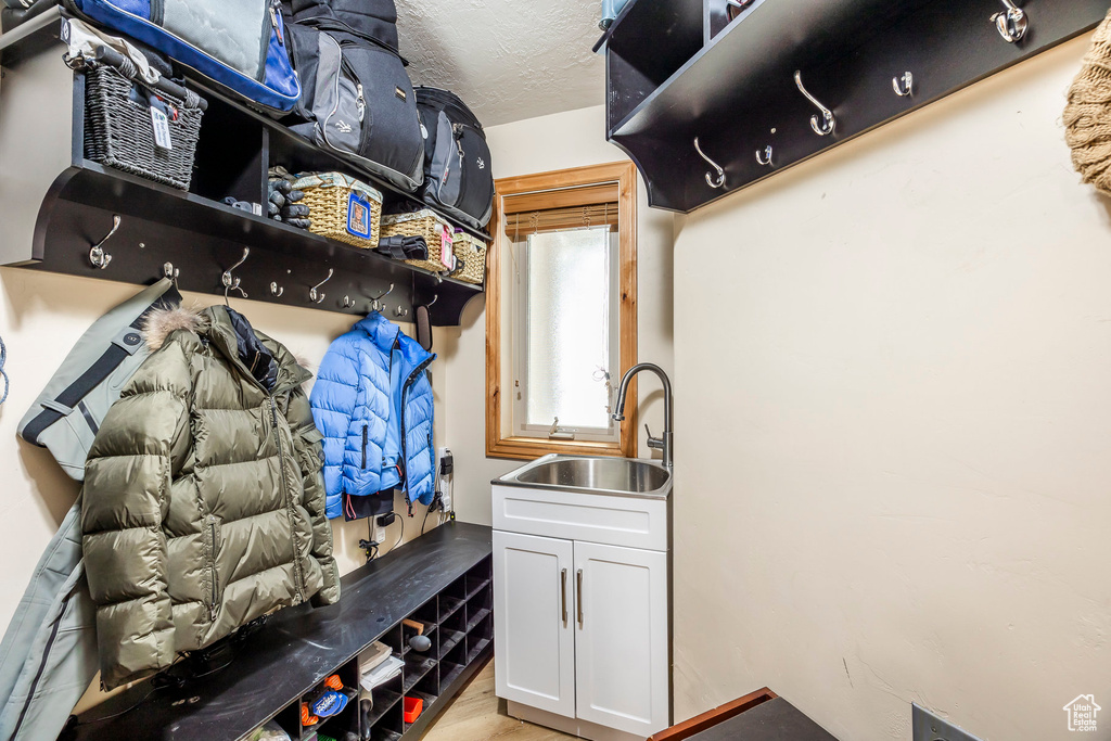 Mudroom featuring a sink and light wood-type flooring