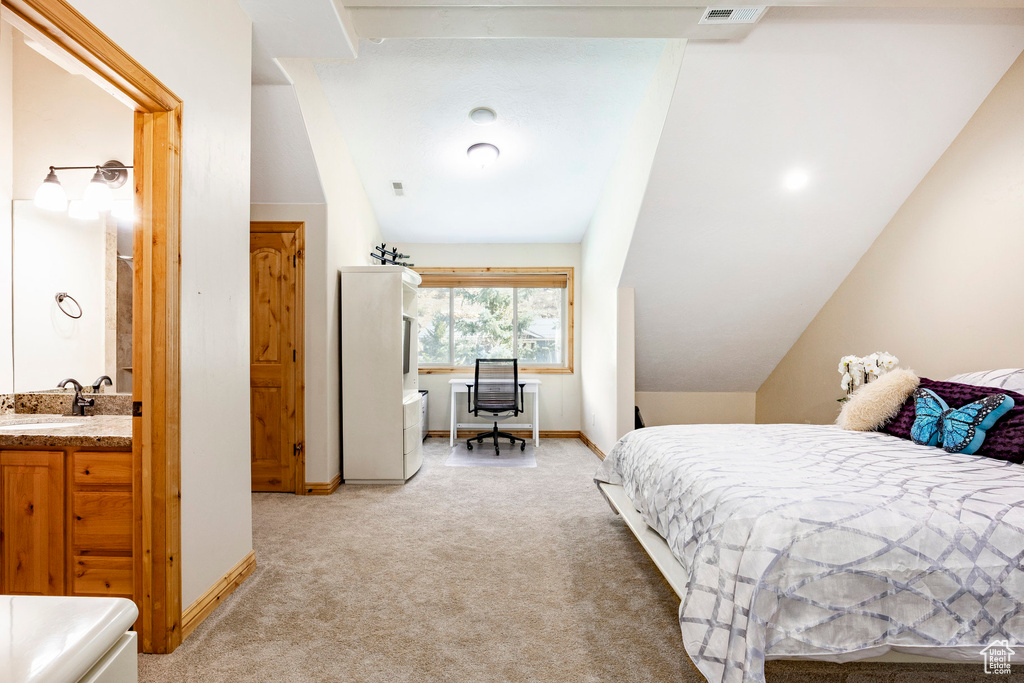 Bedroom featuring light carpet, a sink, and baseboards