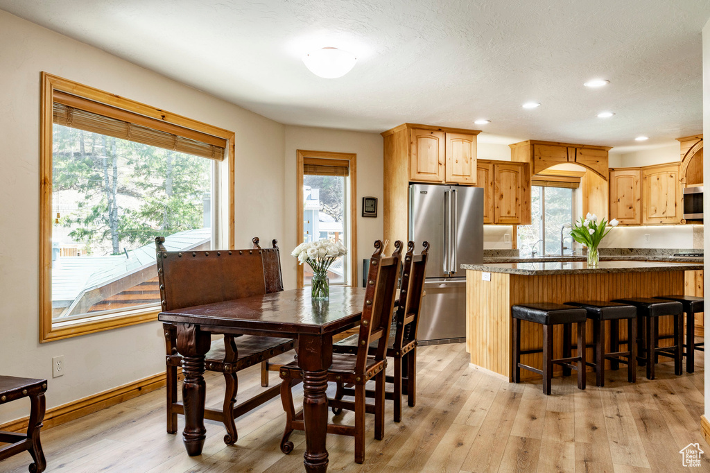 Dining space featuring recessed lighting, light wood-style flooring, and baseboards