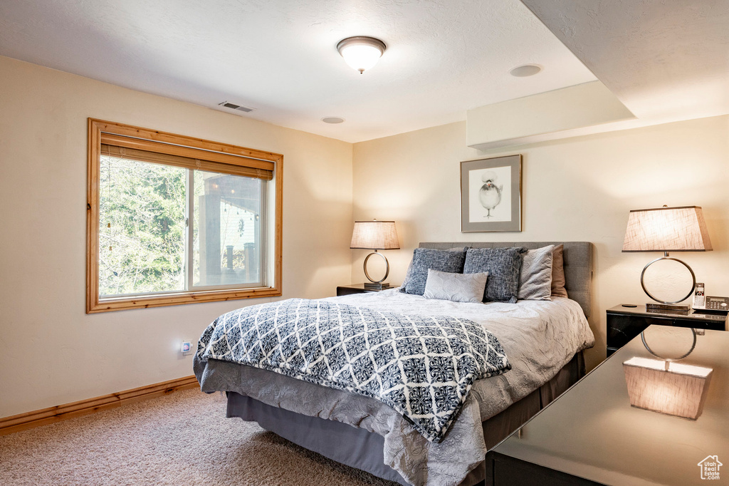 Bedroom featuring carpet floors and baseboards