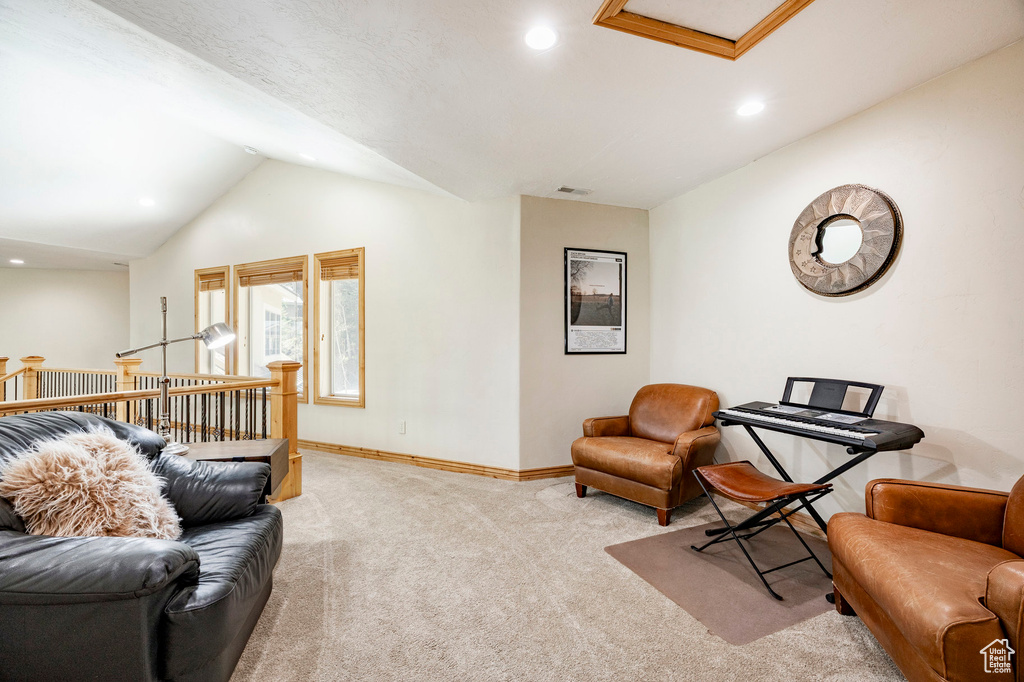 Living area featuring carpet flooring, lofted ceiling, baseboards, and recessed lighting