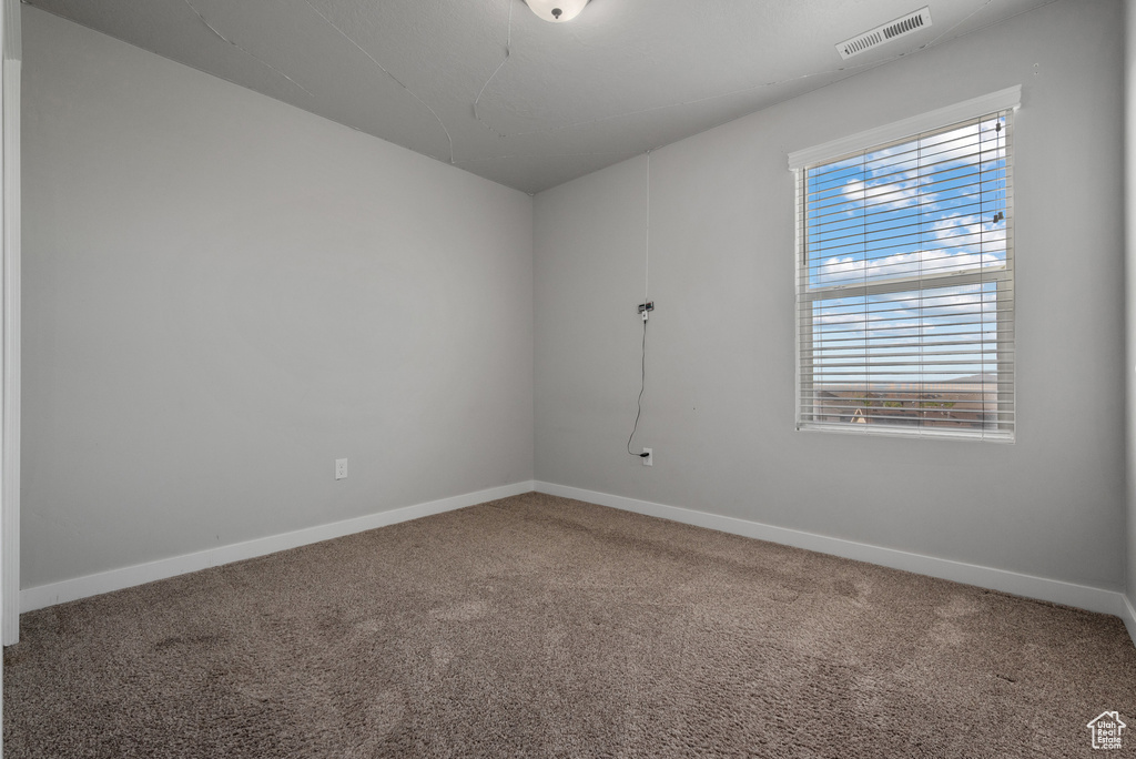 Unfurnished room with carpet floors and baseboards