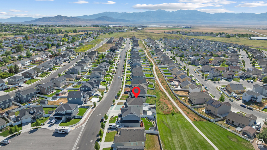 Aerial overview of property's location with nearby suburban area and mountains