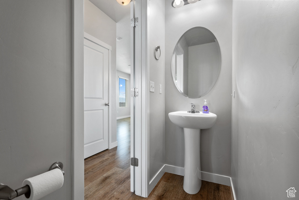 Bathroom with wood finished floors and baseboards