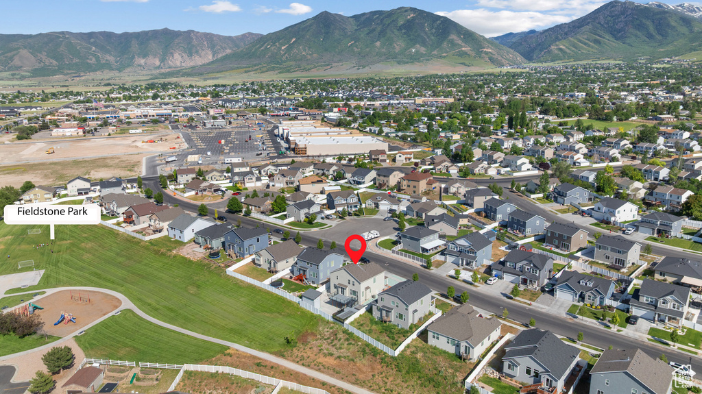 View of property location with a mountain backdrop and nearby suburban area