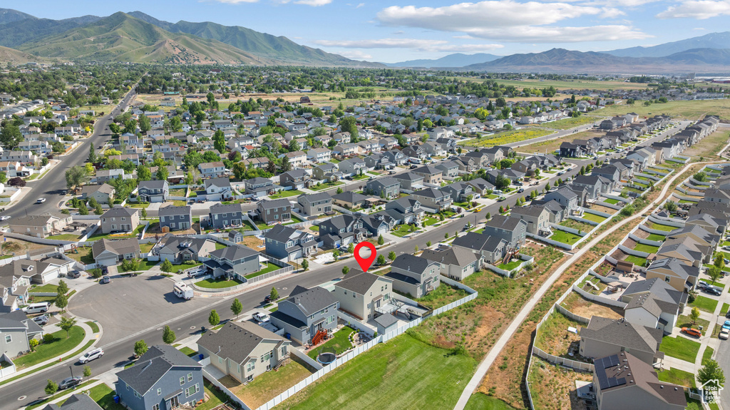 Aerial view of property's location with a mountainous background and nearby suburban area