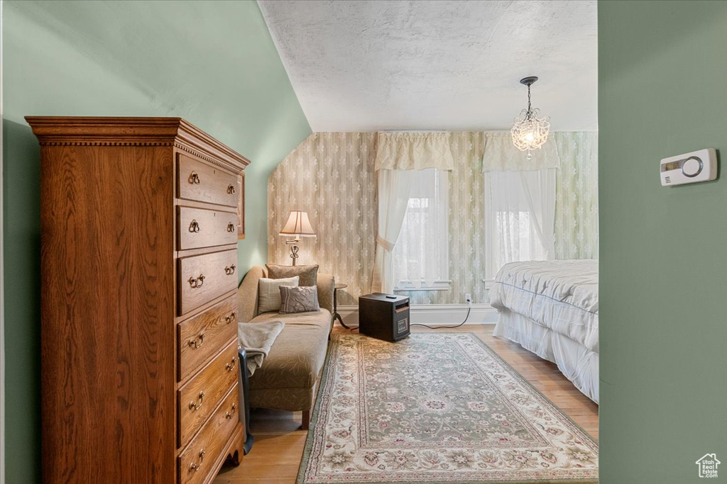 Bedroom featuring a textured ceiling and light hardwood / wood-style flooring