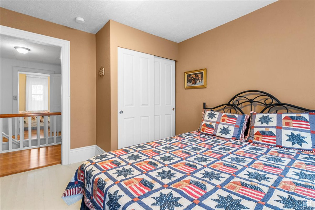 Bedroom featuring hardwood / wood-style floors and a closet