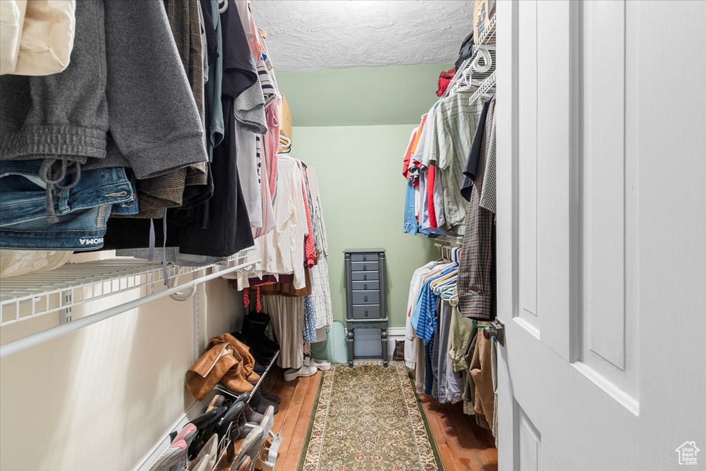 Walk in closet featuring hardwood / wood-style floors