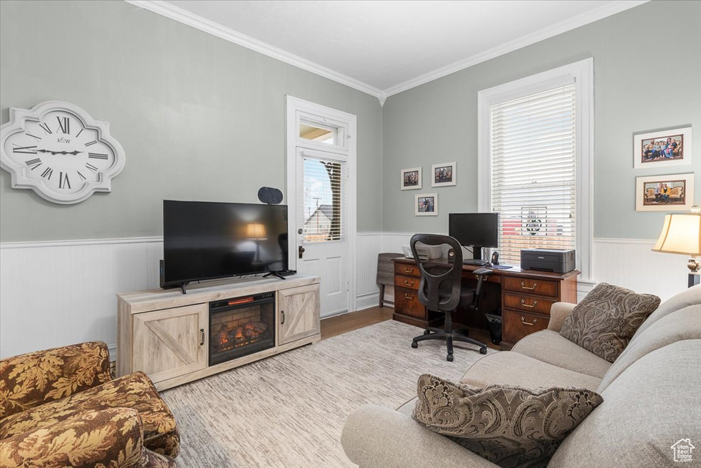 Office space featuring light wood-type flooring and crown molding