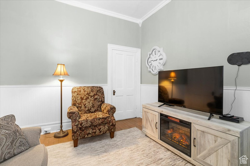 Interior space with crown molding and light wood-type flooring