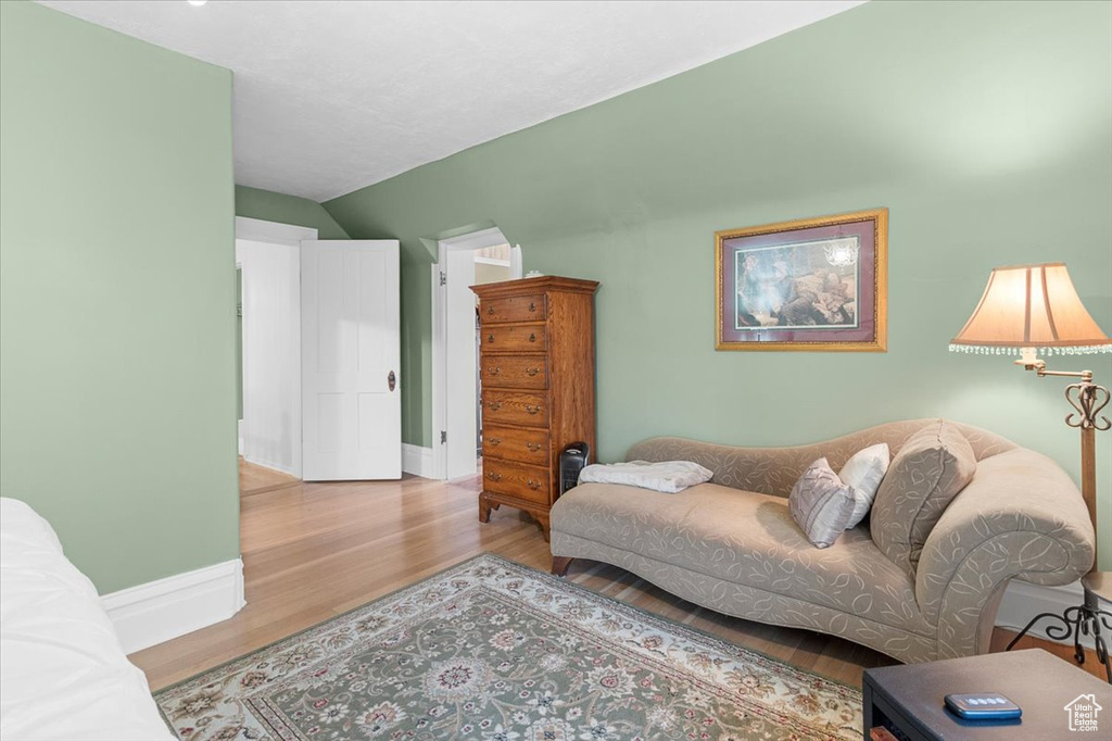 Living room with vaulted ceiling and hardwood / wood-style flooring