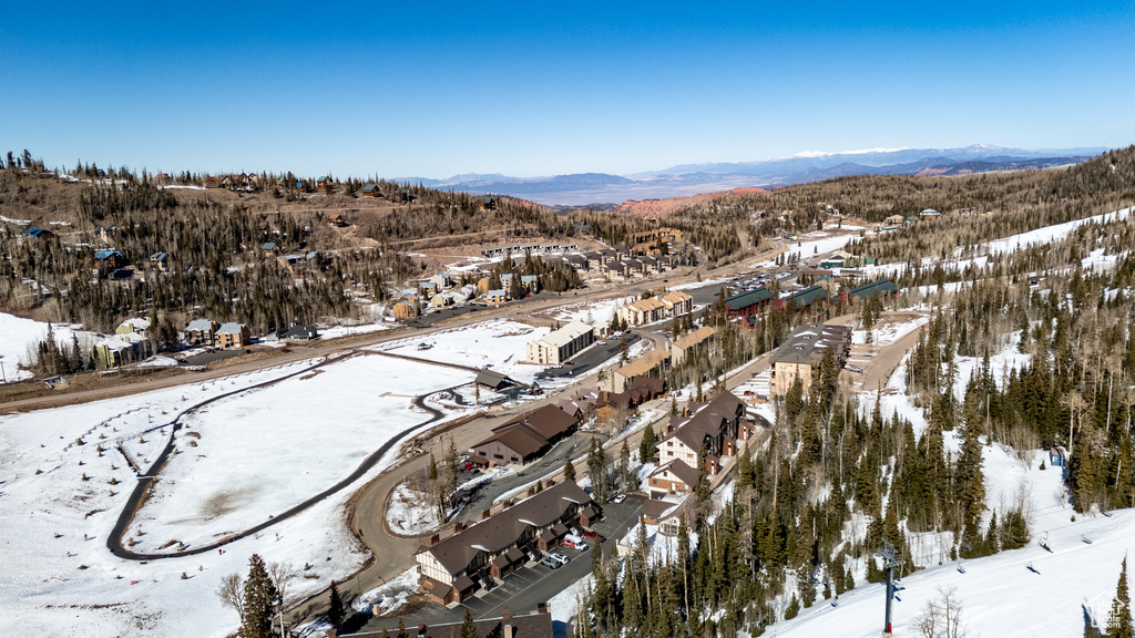 Snowy aerial view with a residential view and a mountain view