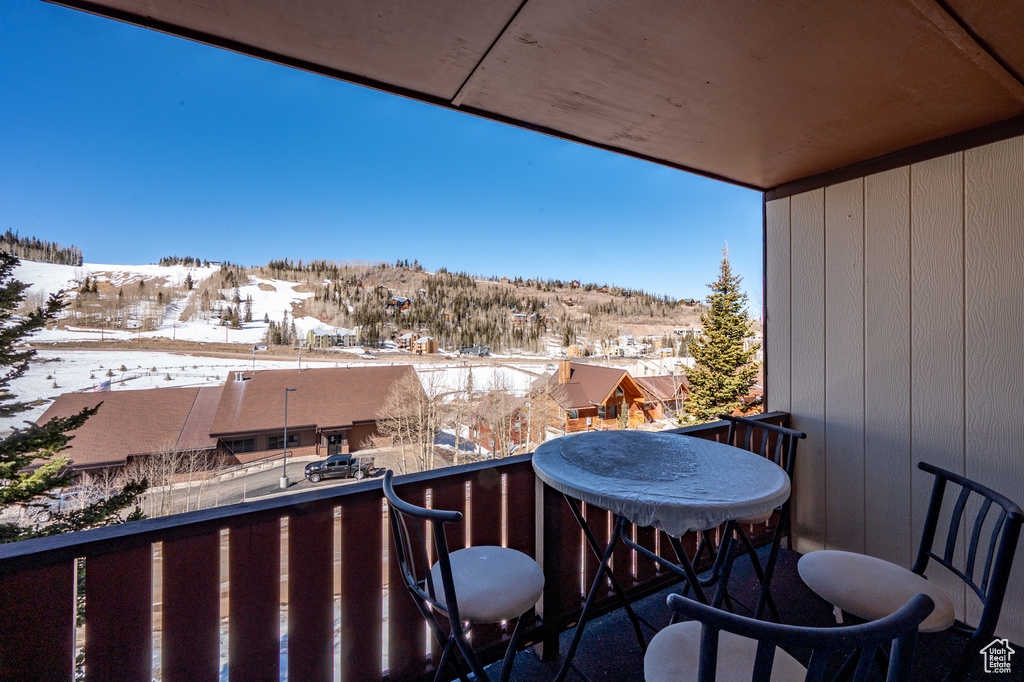 View of snow covered back of property