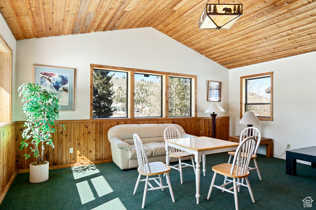 Dining space with carpet, wood ceiling, and lofted ceiling