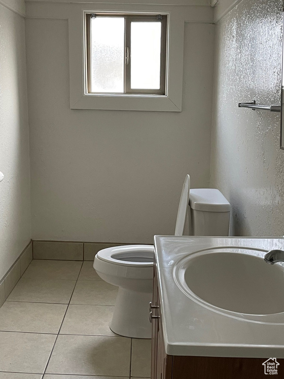 Bathroom featuring tile patterned flooring, vanity, and toilet