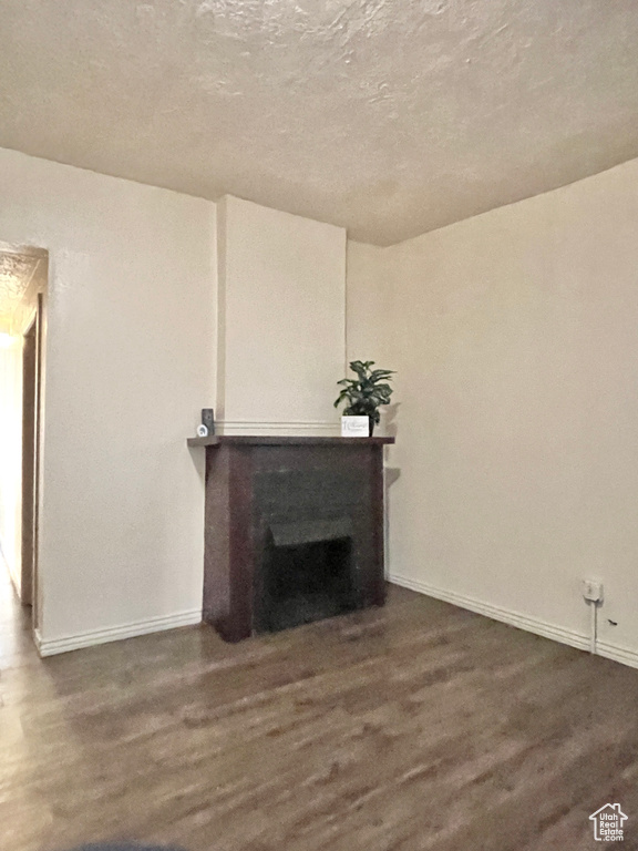 Living room featuring dark hardwood / wood-style flooring and a fireplace