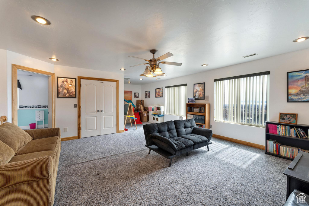 Living room with carpet floors and ceiling fan