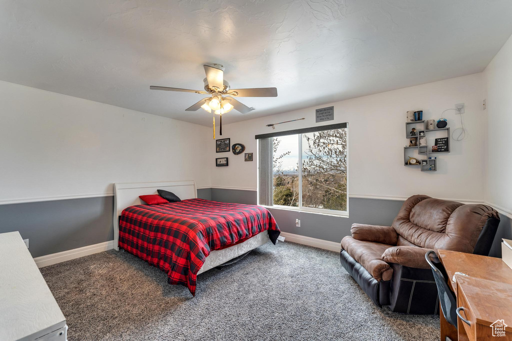Carpeted bedroom featuring ceiling fan