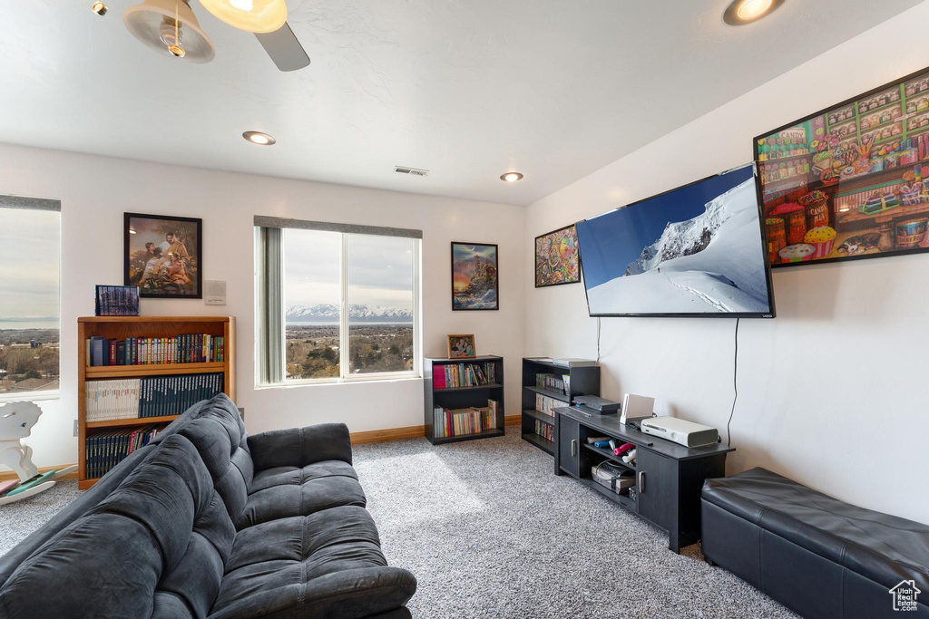 Living room featuring ceiling fan and carpet floors
