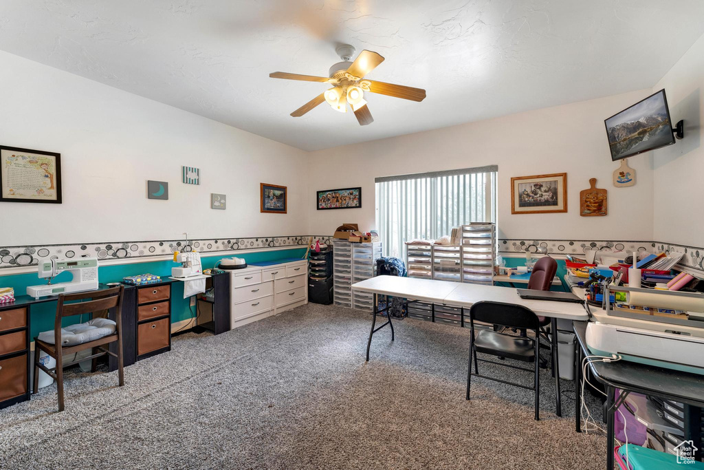 Carpeted home office with ceiling fan