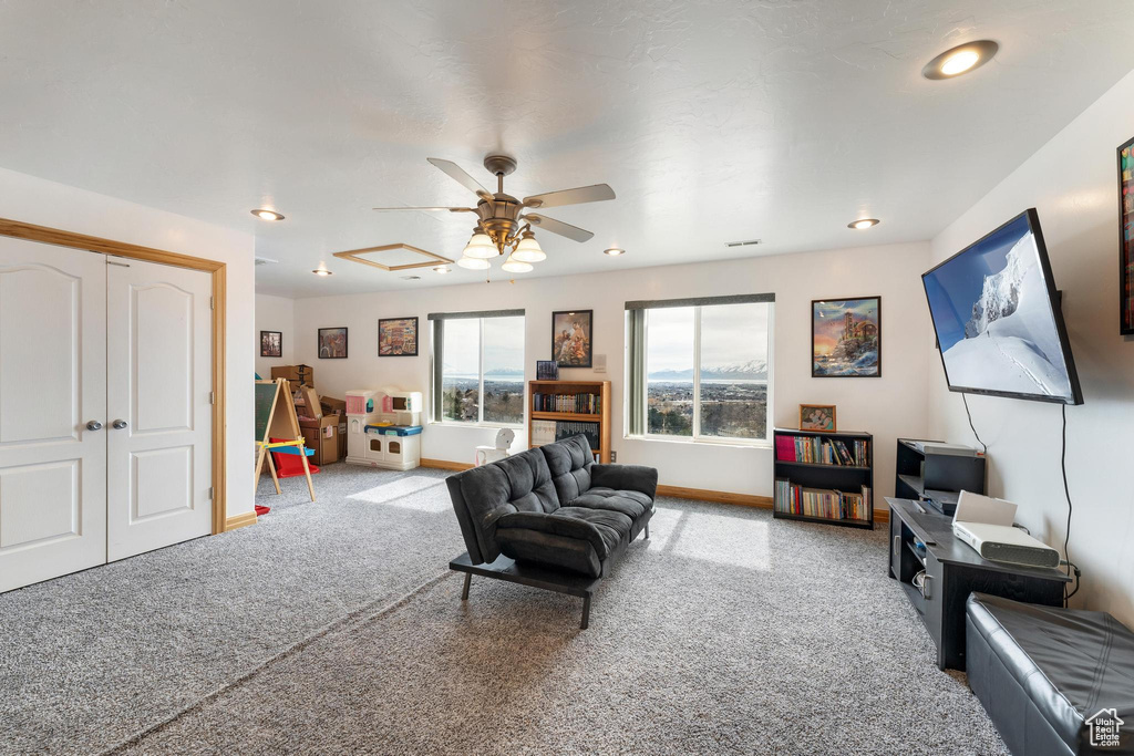 Living room featuring carpet flooring and ceiling fan