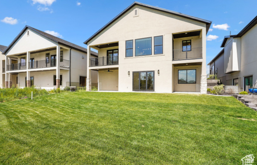 Rear view of house with a lawn