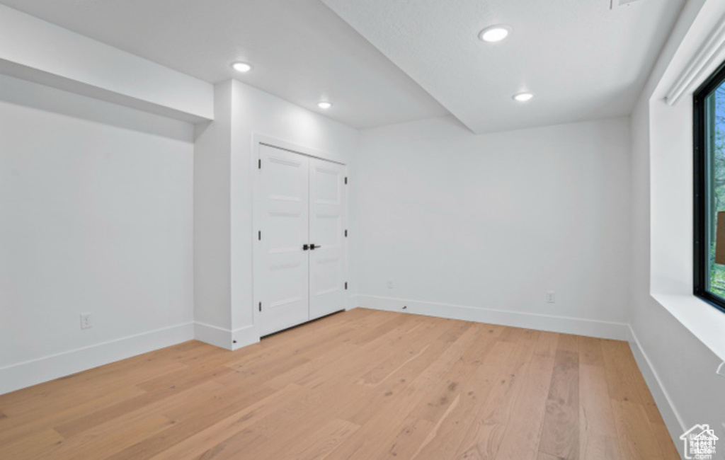 Empty room with light hardwood / wood-style floors