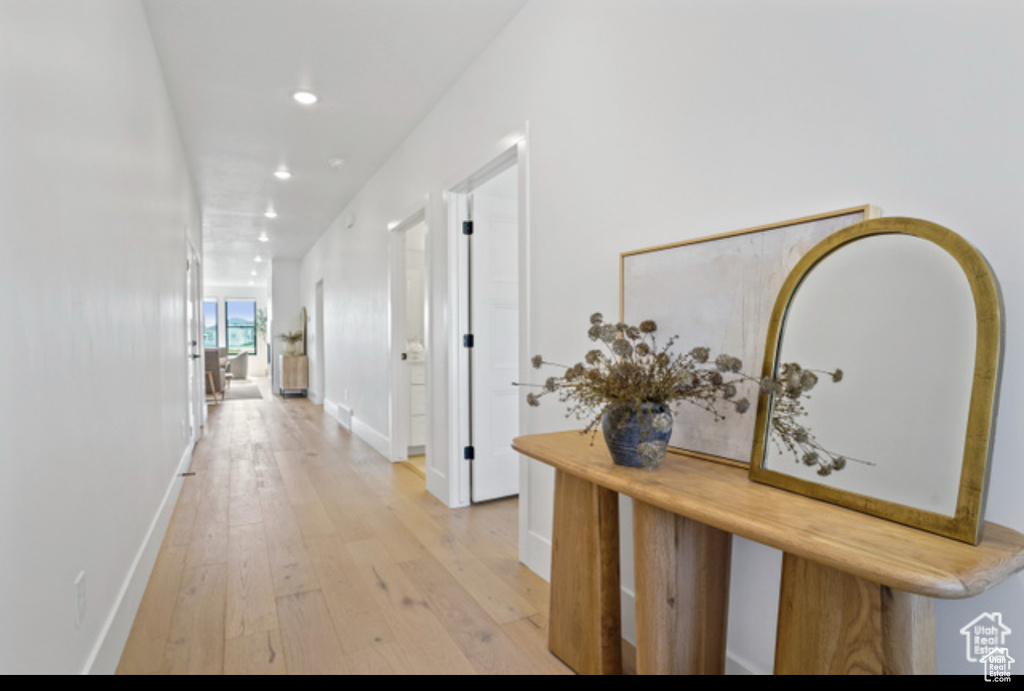 Corridor with light hardwood / wood-style floors