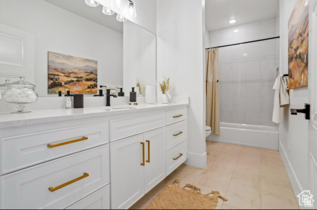Bathroom featuring vanity and shower / bath combo