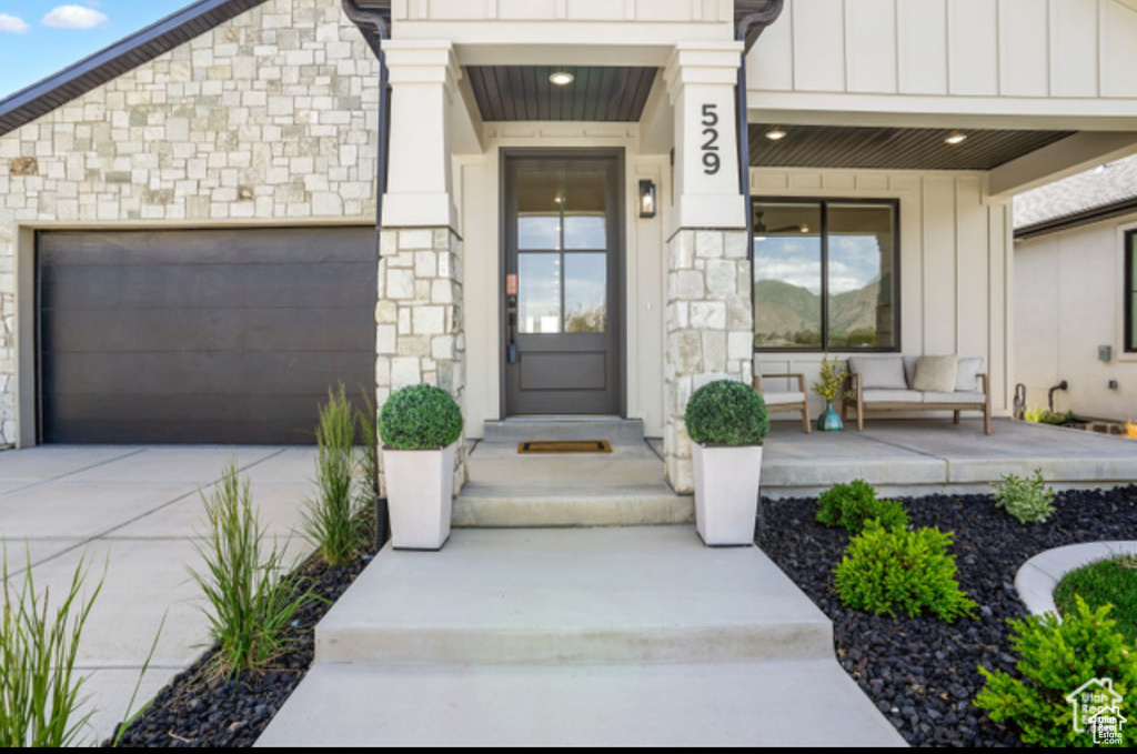 Property entrance with a garage and a porch
