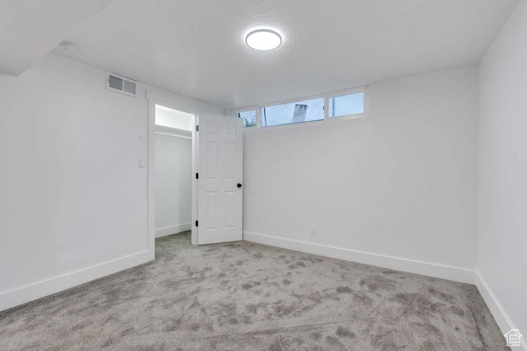 Basement with light colored carpet